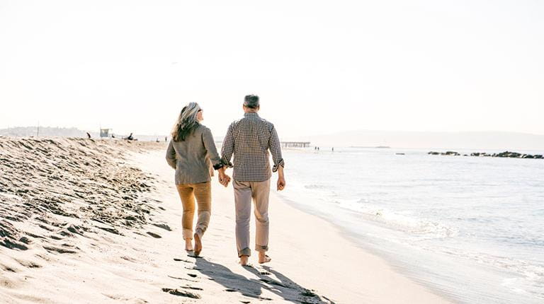Older people walking on a beach