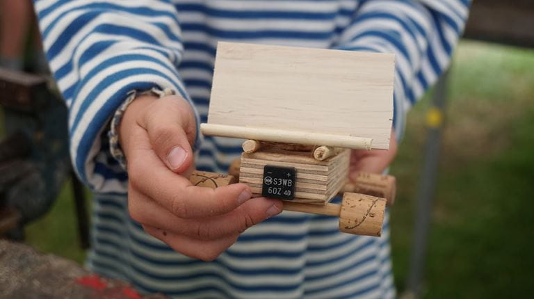 Ein Kind bastelt mit Holz.