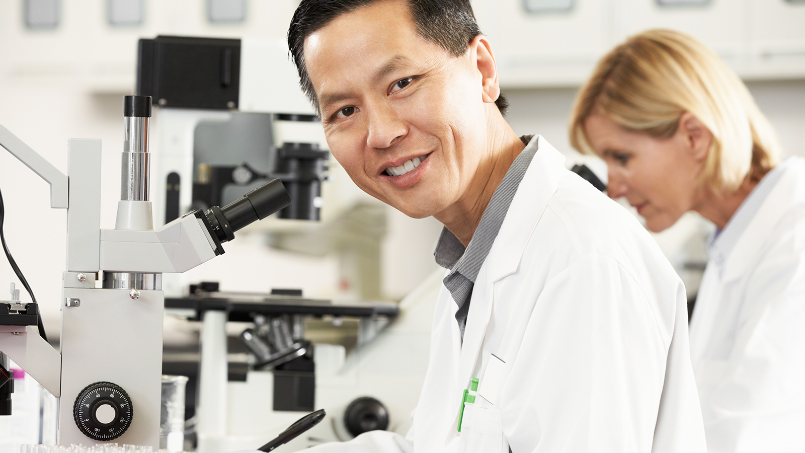 Asian male and caucasian female in a lab